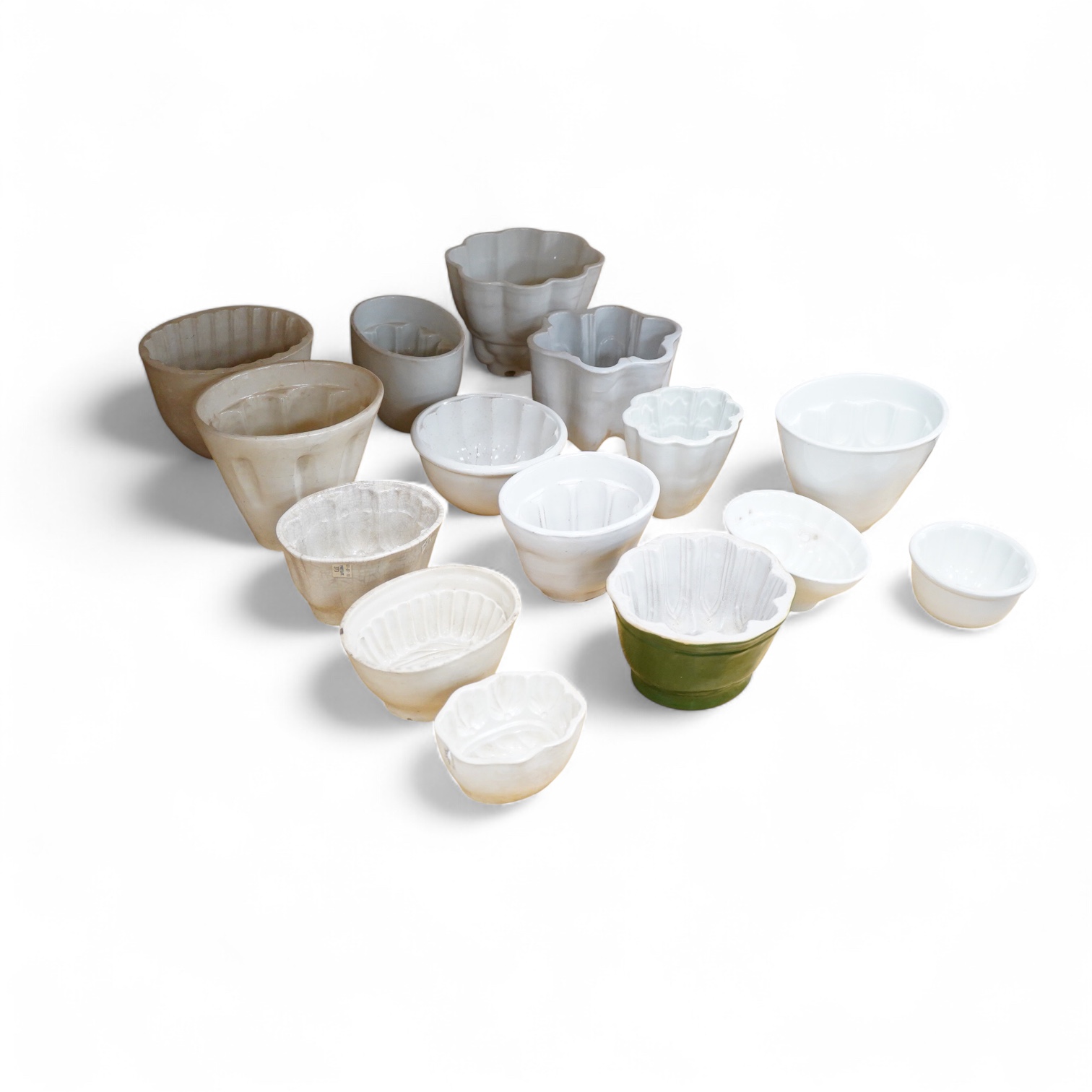 A collection of fifteen mostly 20th century ceramic jelly moulds, largest 16cm high